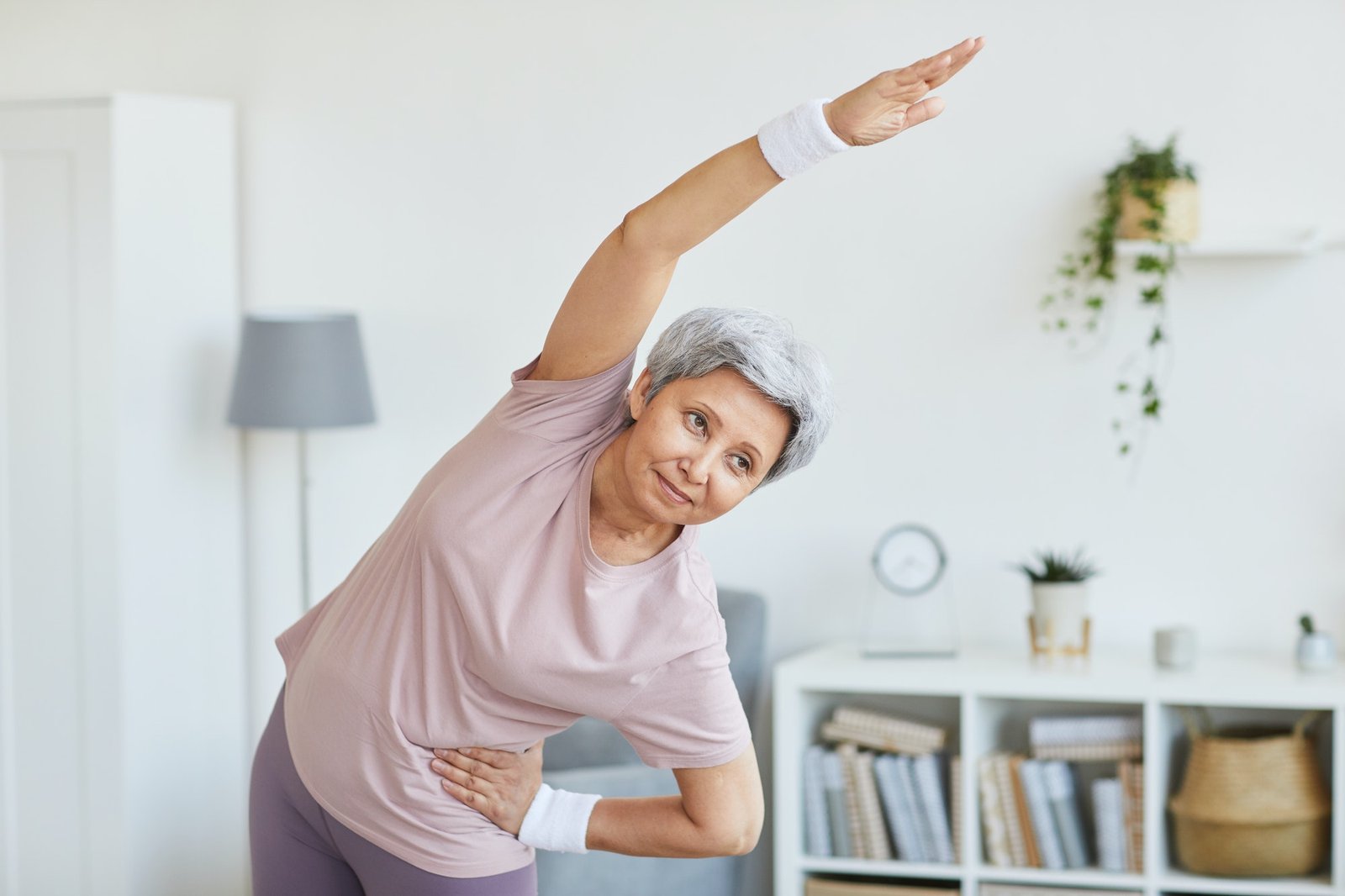 Senior woman exercising at home